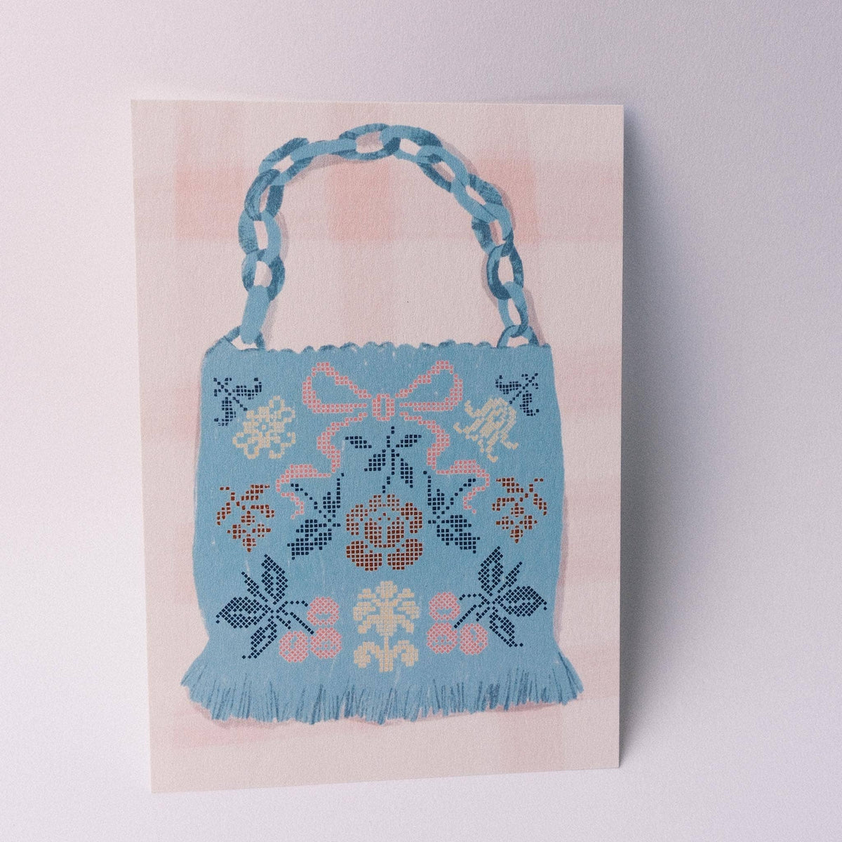 Carte postale A6 — Sac bleu en point de croix — Isobel Rose Illustration